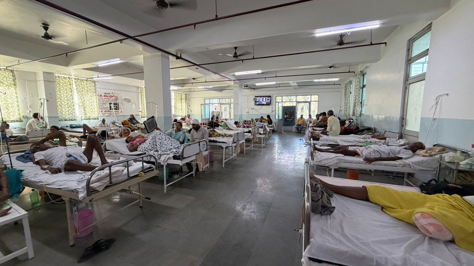 Spacious inpatient ward with medical staff.